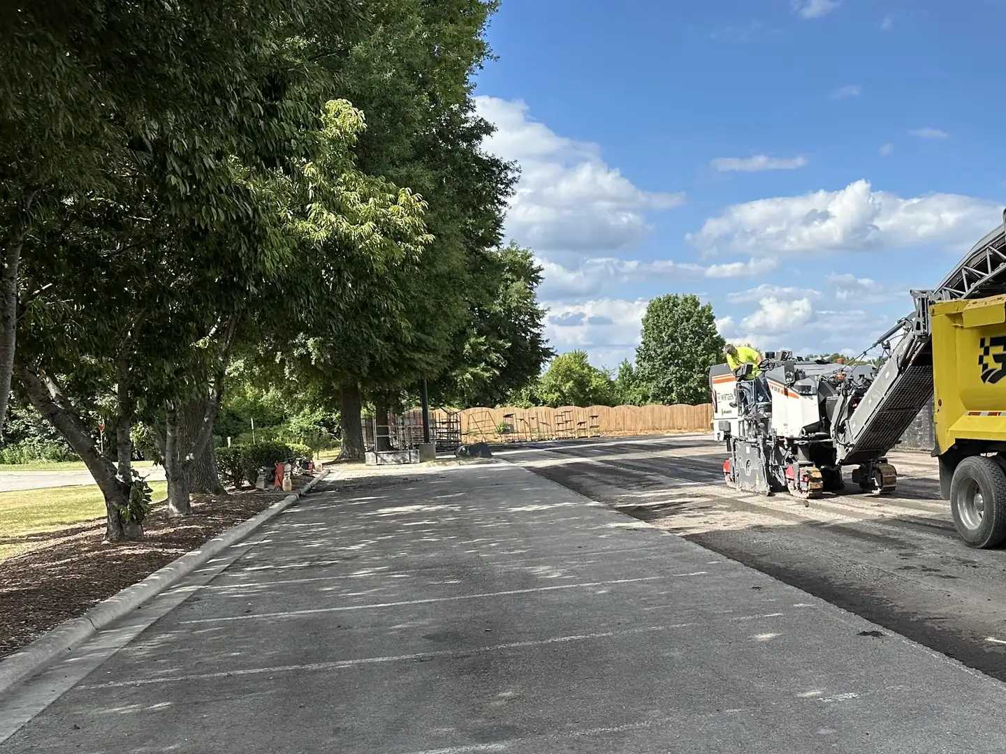 Milling machine conveyor loading millings into a dump truck, asphalt milling