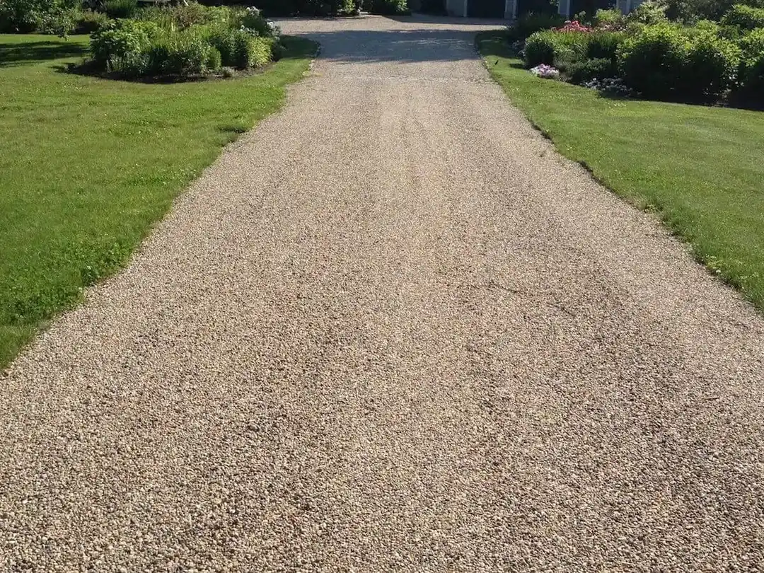 Stone chip driveway running between lawns, chip seal driveway