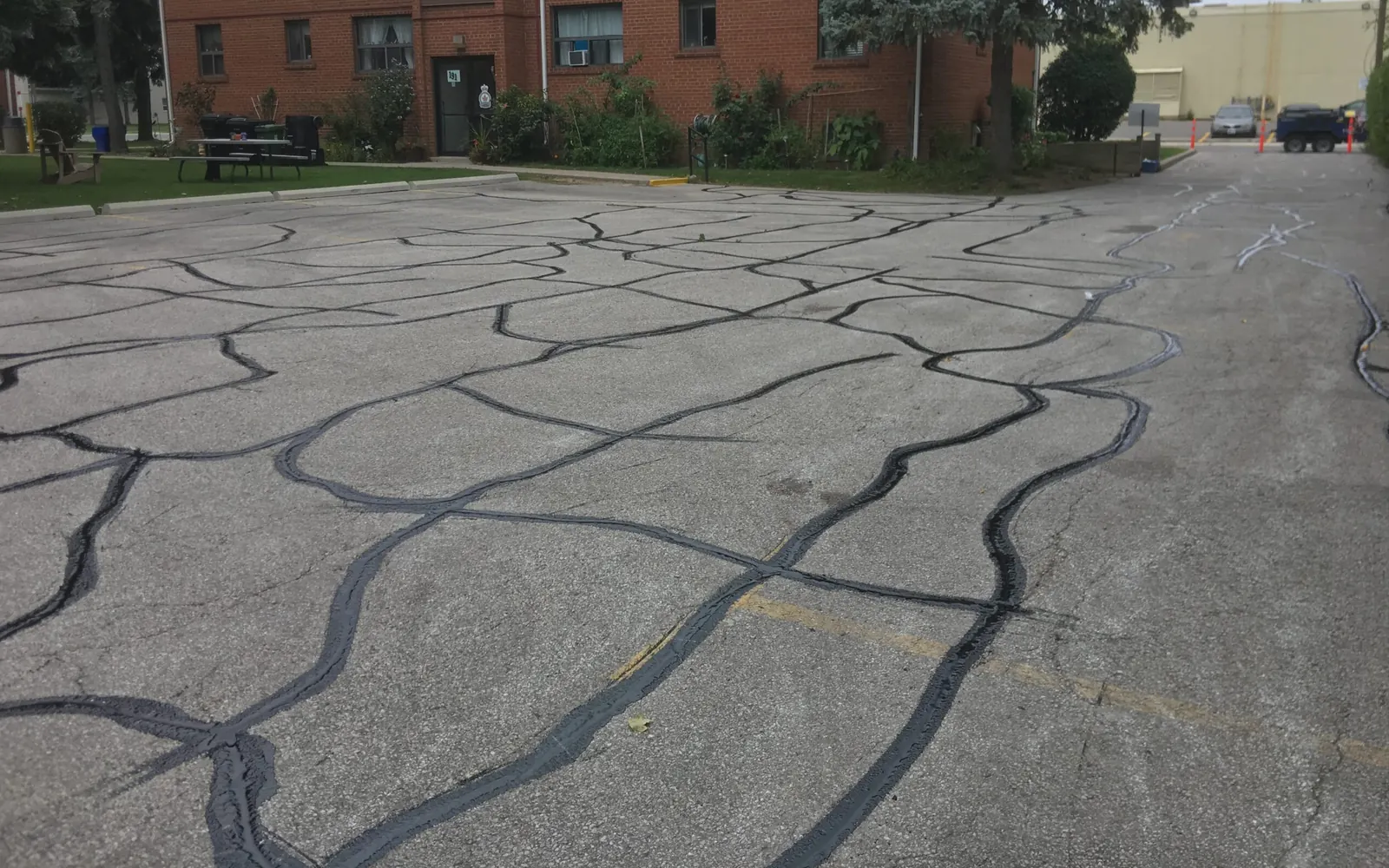 Routed cracks sealed across a parking lot, crack sealing